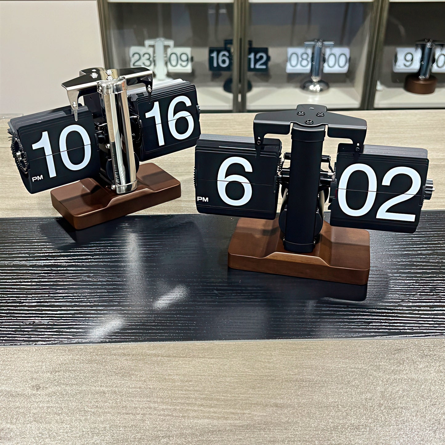 Flip clock with wooden base displaying time on a wooden surface.