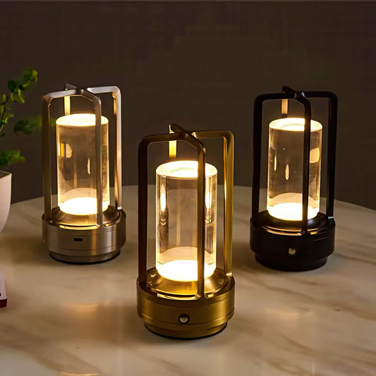 Three lantern-style lamps emitting a warm glow on a marble surface.