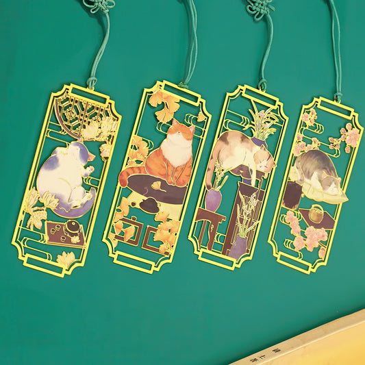Four decorative bookmarks with cat illustrations on a teal background