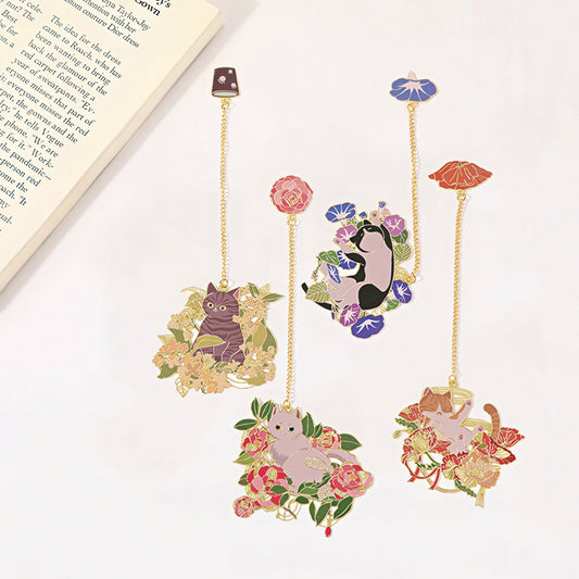 Decorative bookmarks with cat illustrations and floral designs on a white surface.