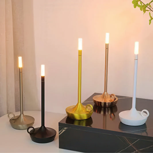 Set of candle holder shaped table lamp on a reflective surface.