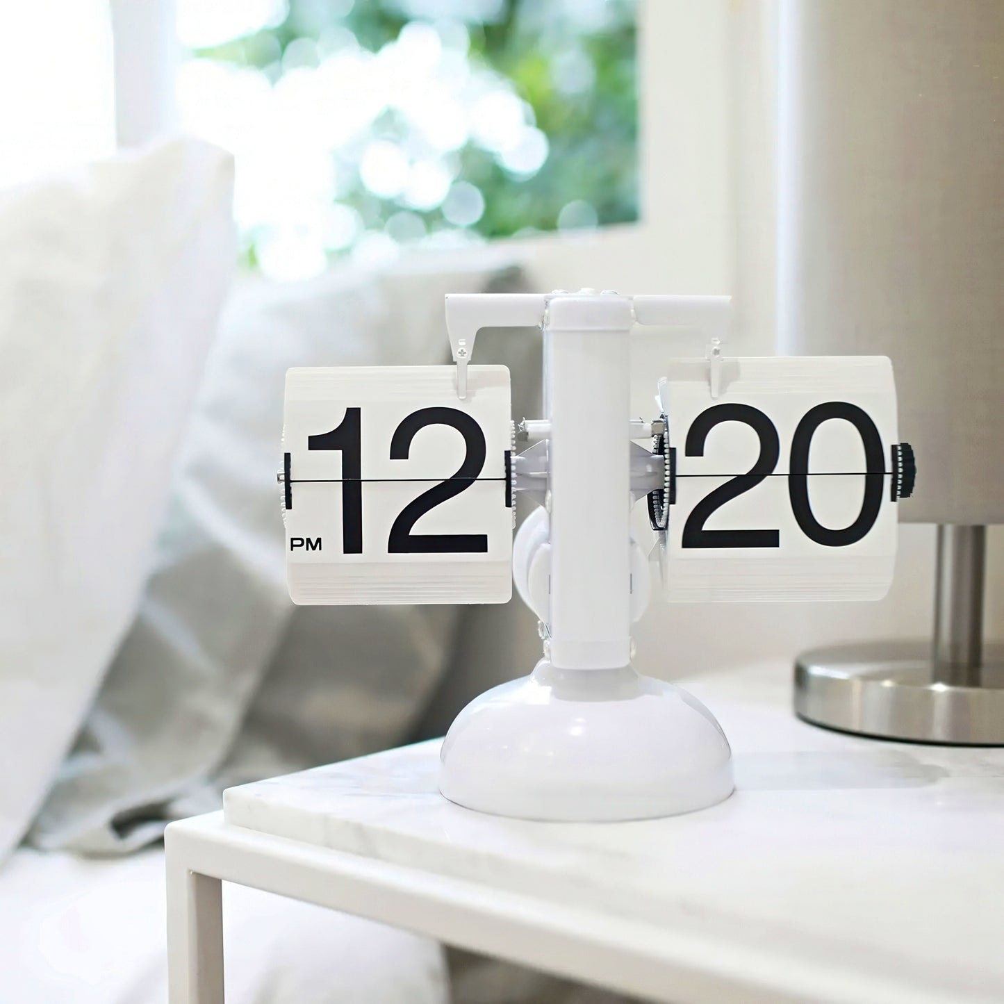 Tabletop clock with flip faces on a white surface