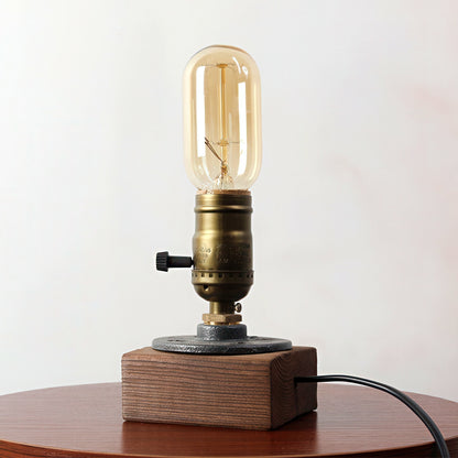 Vintage-style table lamp with wooden base and brass fitting on a white background
