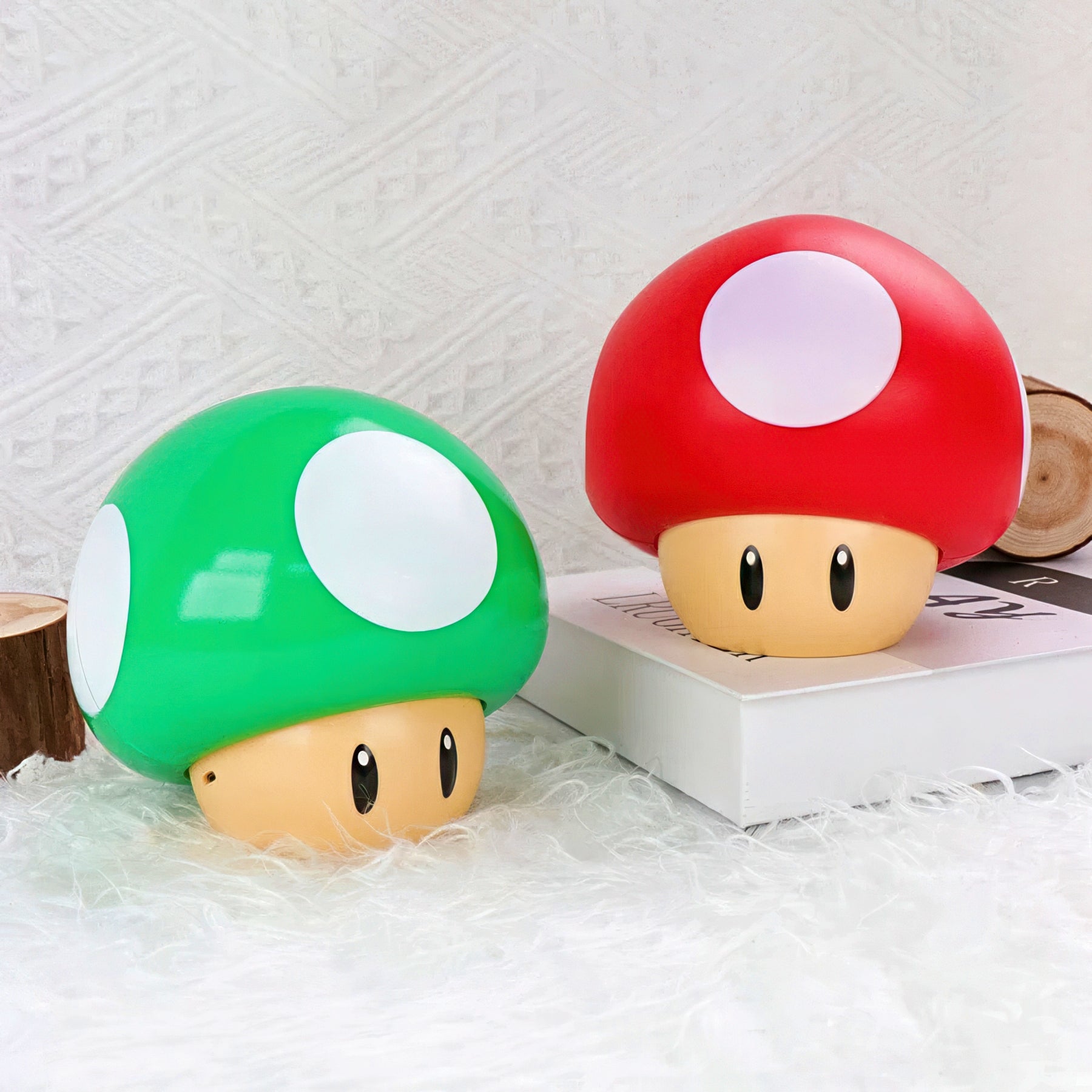 Two mushroom-shaped lamps, one green and one red, on a textured surface.
