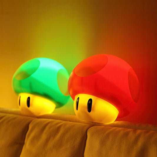 Two colorful mushroom-shaped night lights on a brown surface with a gradient background.