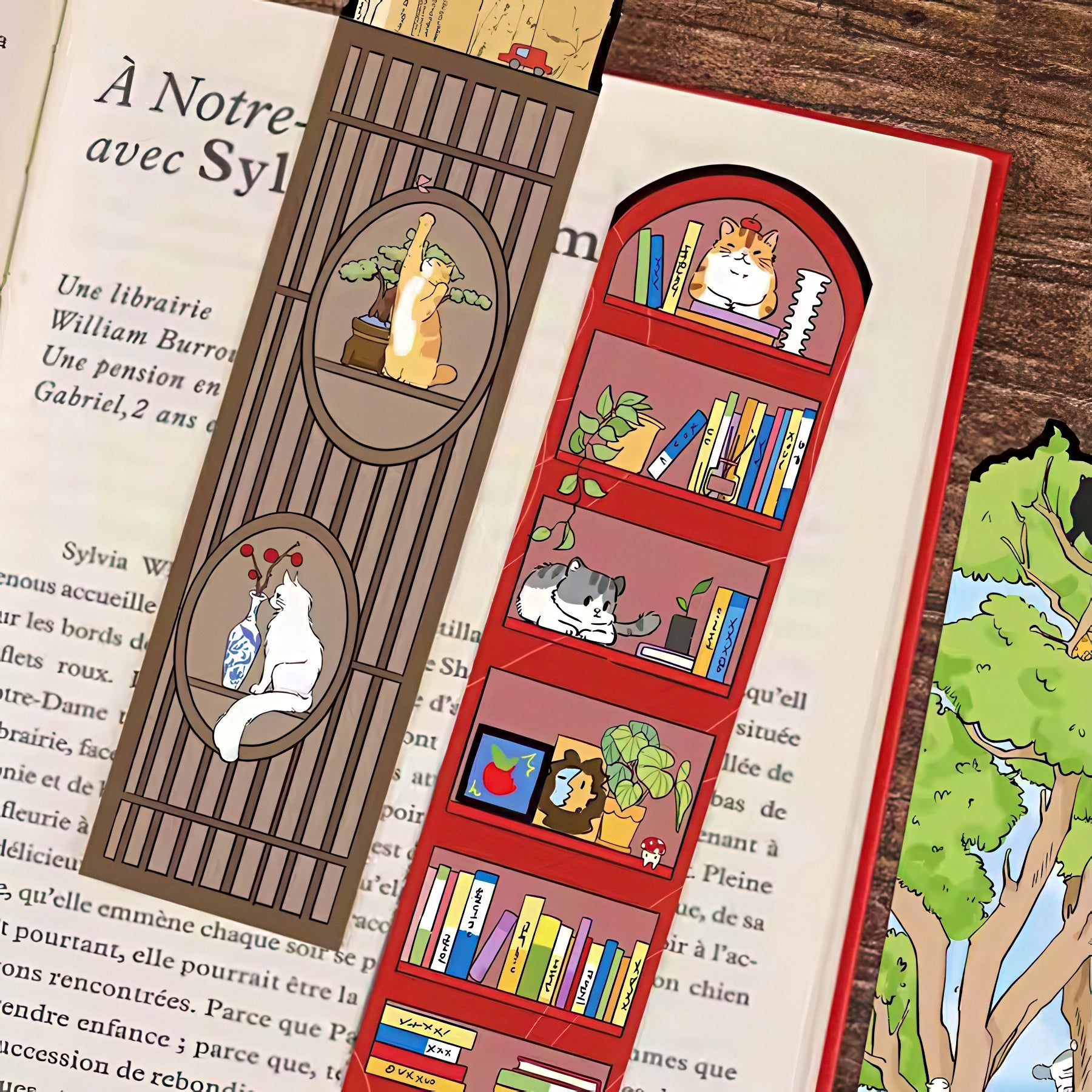 Two illustrated bookmarks with cat-themed designs on a book page.