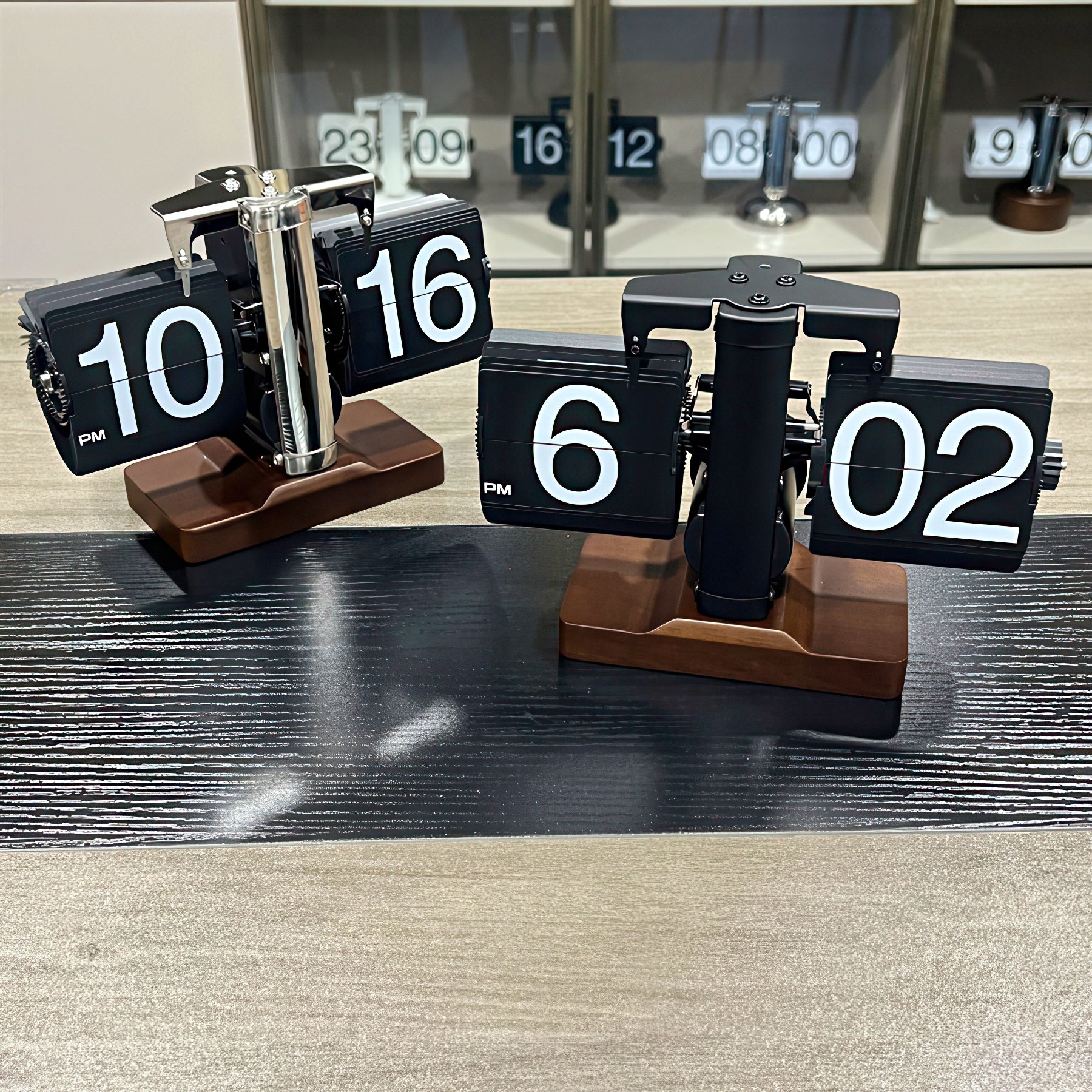 Flip clock with wooden base displaying time on a wooden surface.