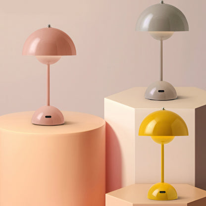 Three table lamps on geometric podiums against a beige background