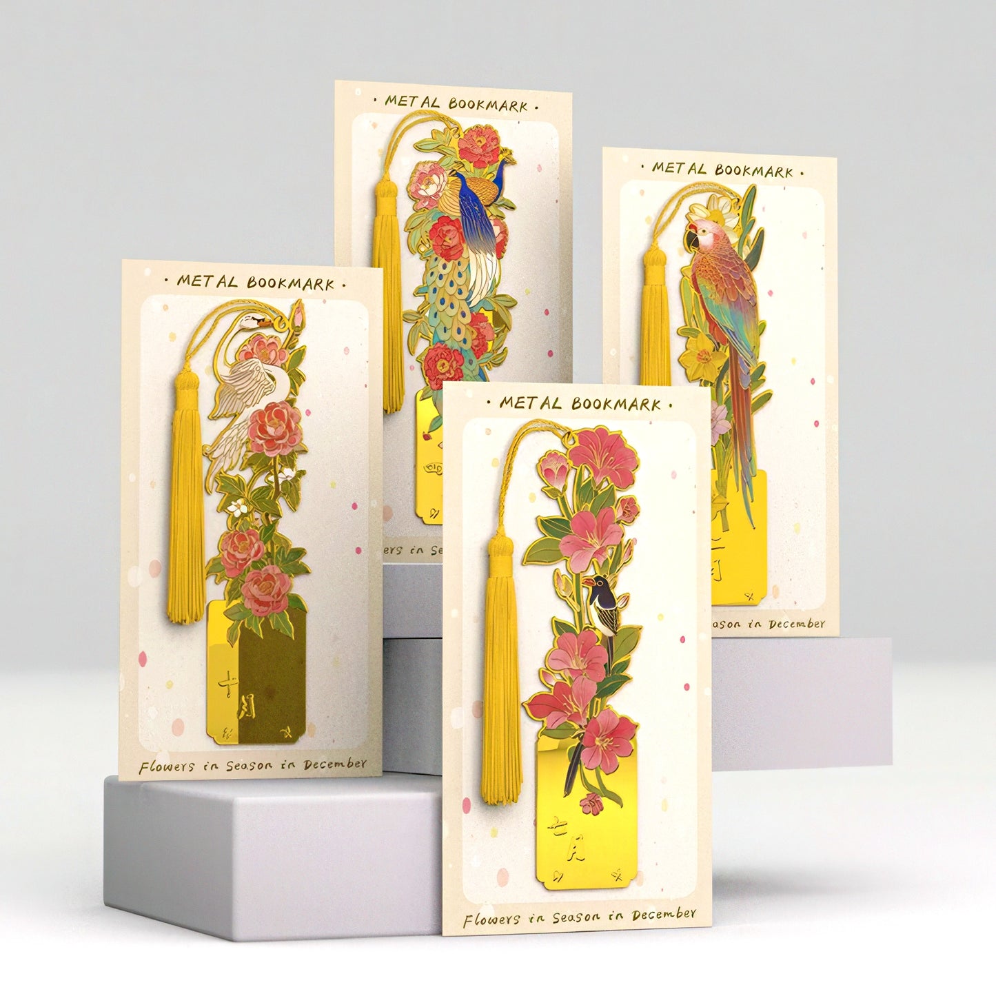 Metal bookmarks with floral and bird designs in packaging