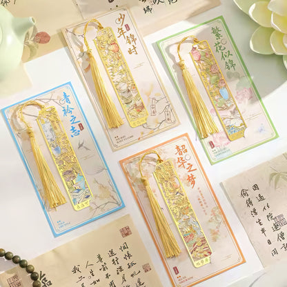 Decorative bookmarks with tassels on packaging against a light background