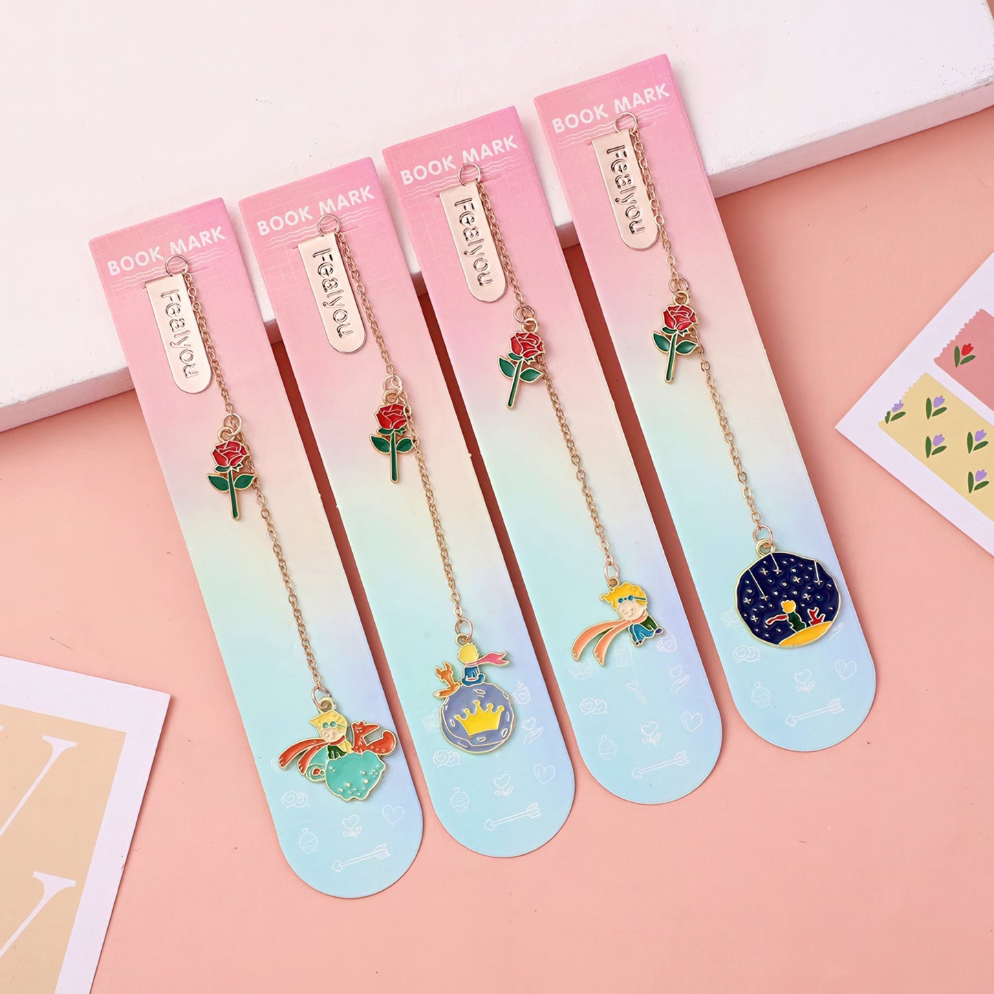 Set of metal charm bookmarks with little prince designs on a gradient background