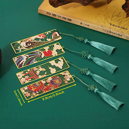 Set of Japanese themed metal bookmarks with tassels on a green surface