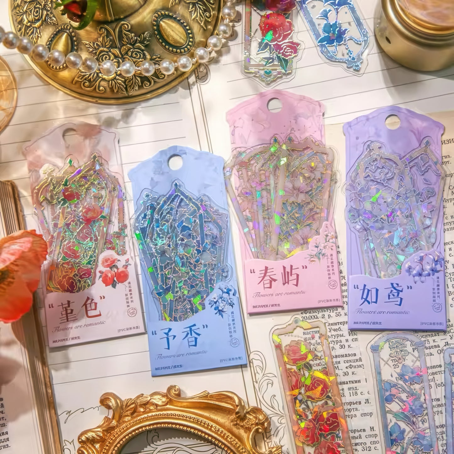 Decorative PVC bookmarks with floral designs on a textured surface