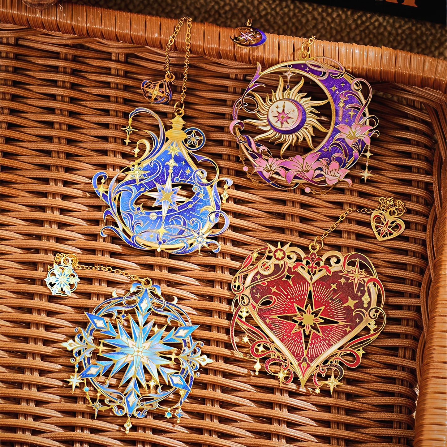 Set of four intricate floral and stars themed metal bookmarks on a woven basket.