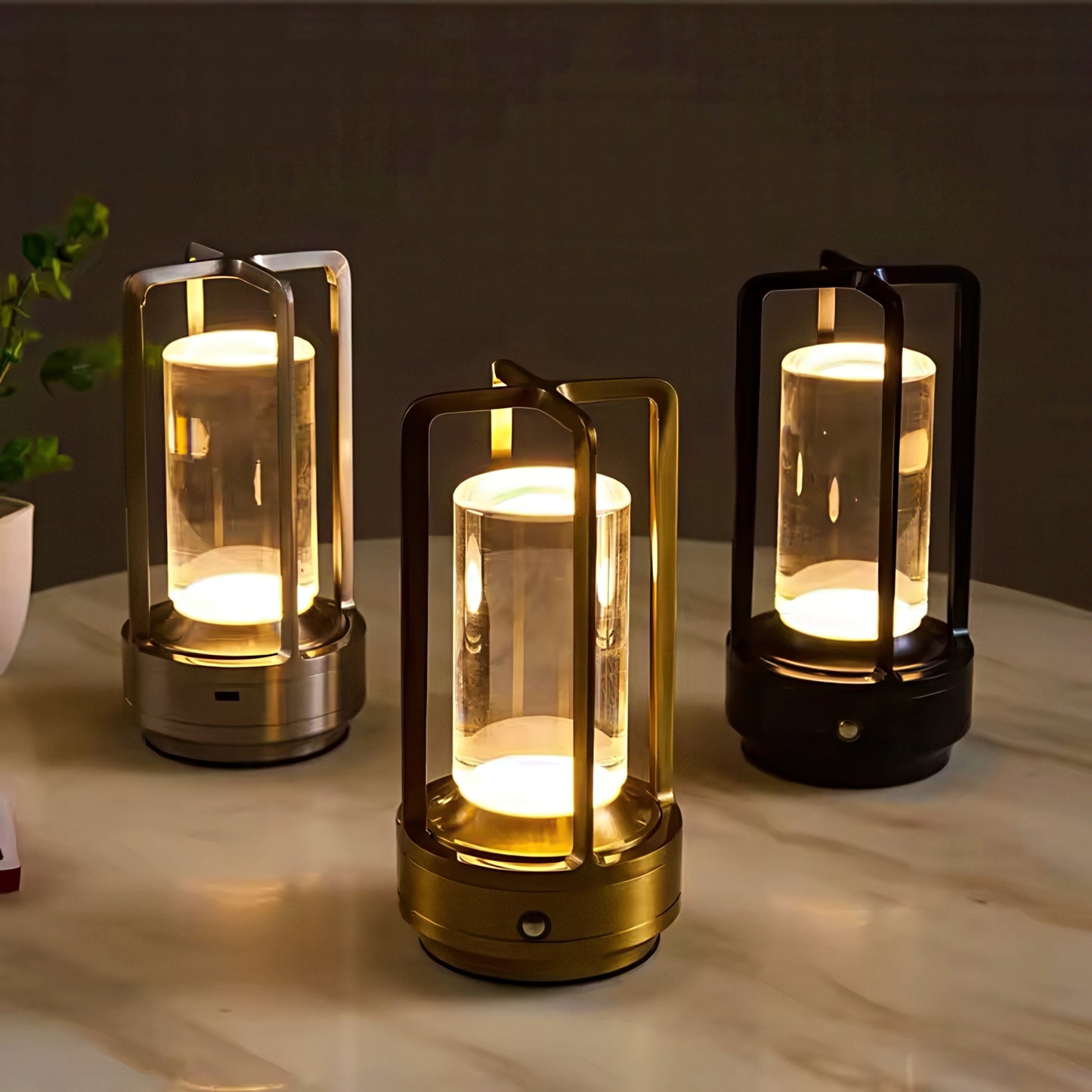 Three lantern-style lamps emitting a warm glow on a marble surface.