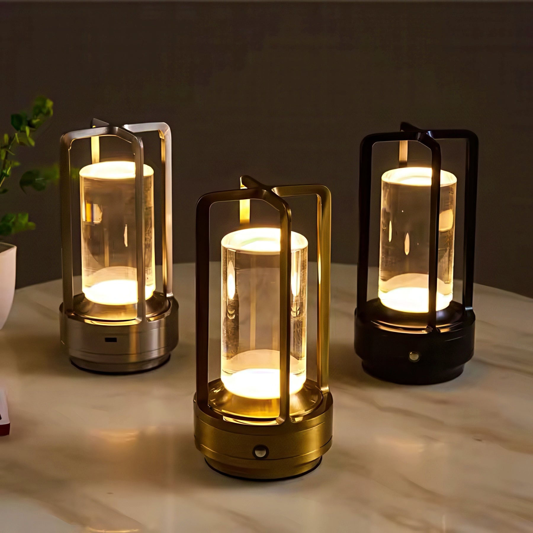 Three lantern-style lamps emitting a warm glow on a marble surface.