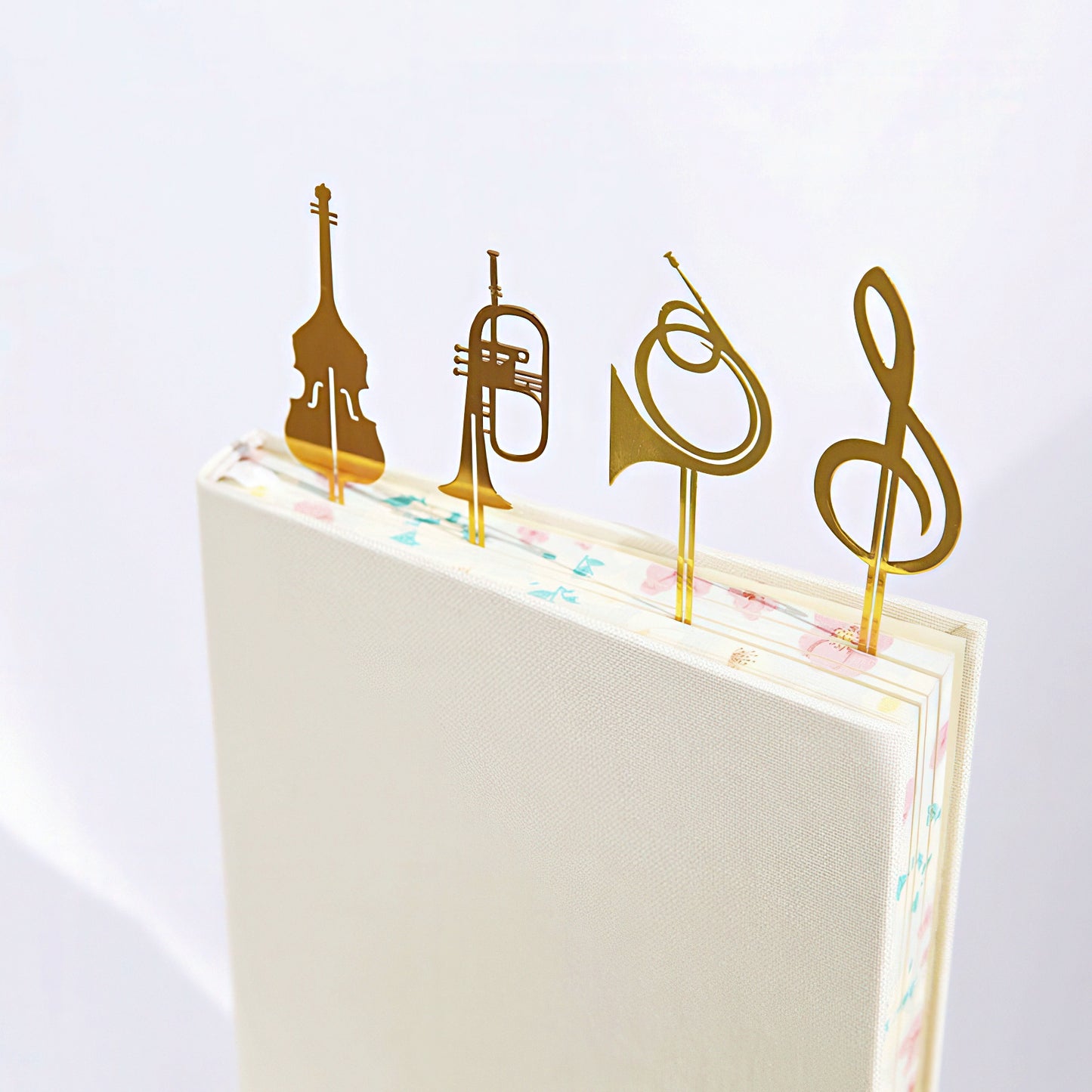Gold musical instrument and note symbol bookmarks on a notebook