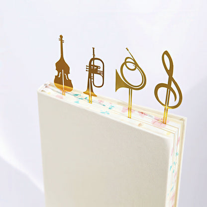 Gold musical instrument and note symbol bookmarks on a notebook