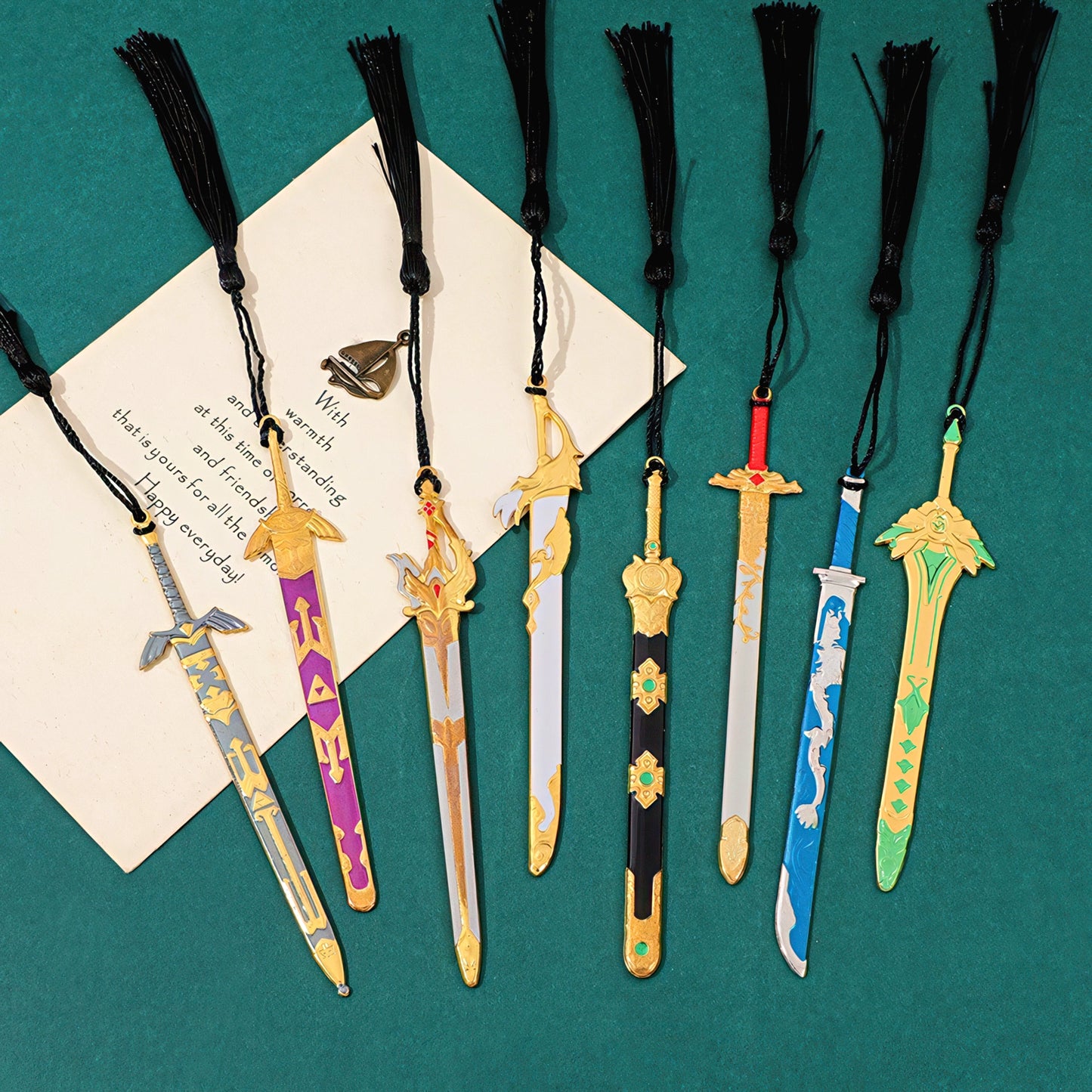 Collection of sword-shaped bookmarks with tassels on a green background