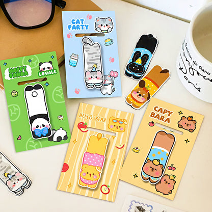 Set of cute animal-themed magnetic bookmarks on a desk