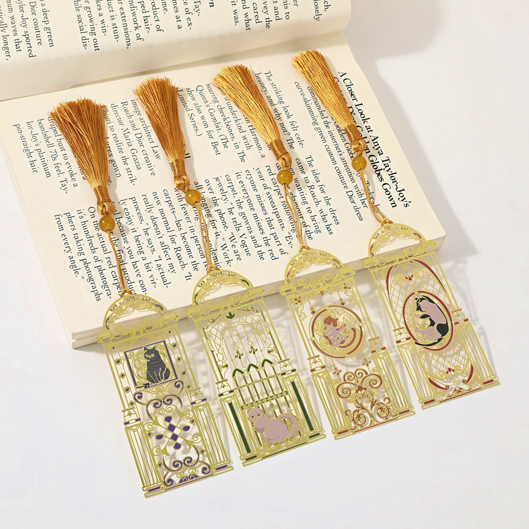 Cat themed metal bookmarks with tassels on an open book