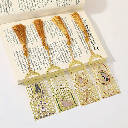 Cat themed metal bookmarks with tassels on an open book