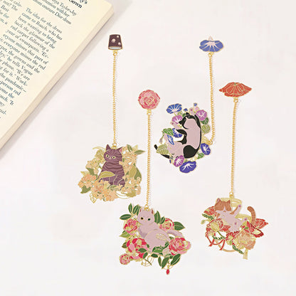 Decorative bookmarks with cat illustrations and floral designs on a white surface.