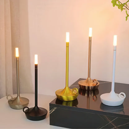 Set of candle holder shaped table lamp on a reflective surface.