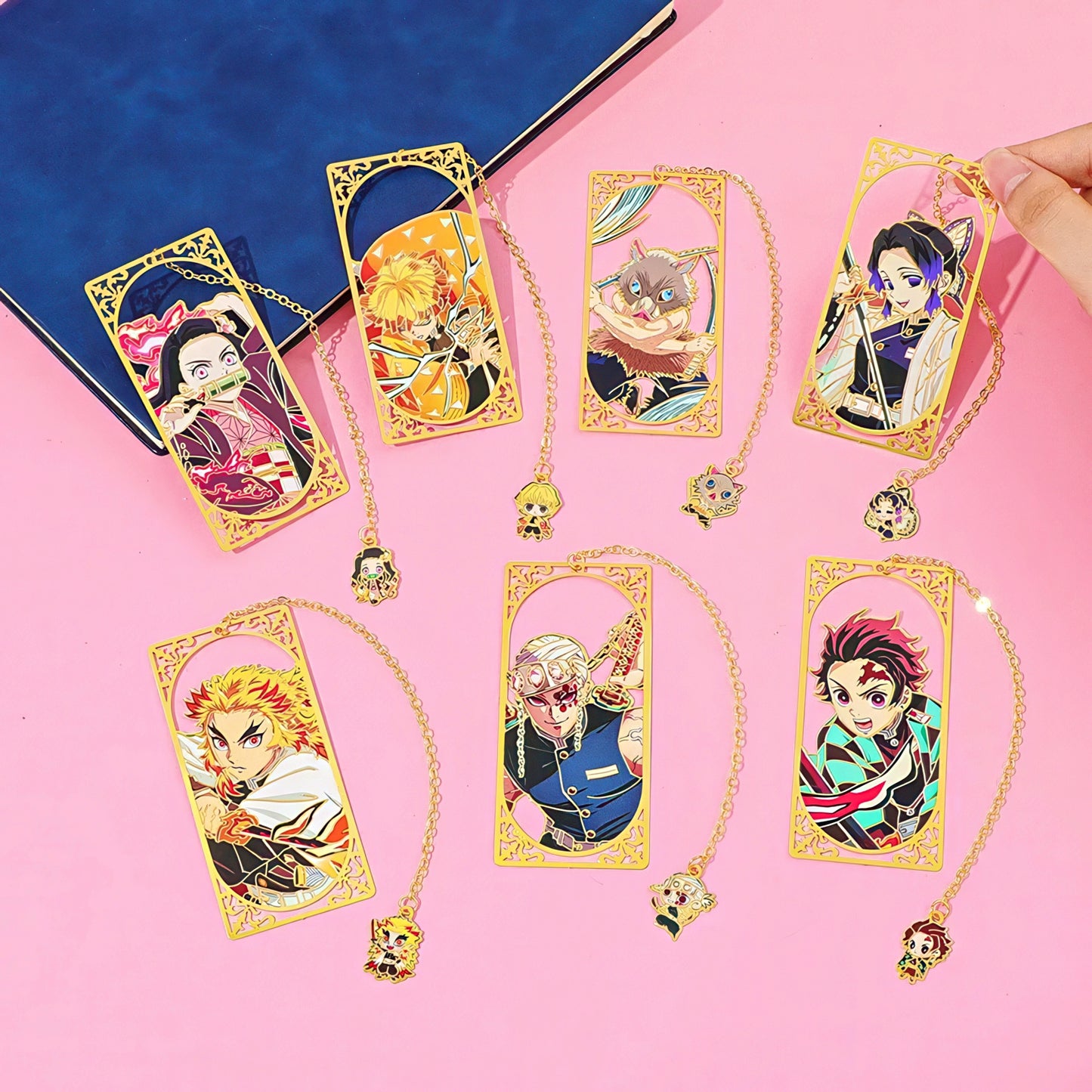 Set of Demon Slayer manga themed metal bookmark on a pink background