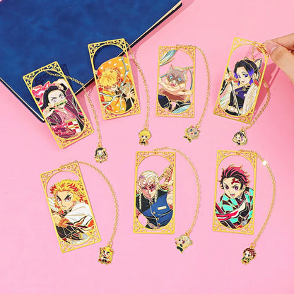 Set of Demon Slayer manga themed metal bookmark on a pink background