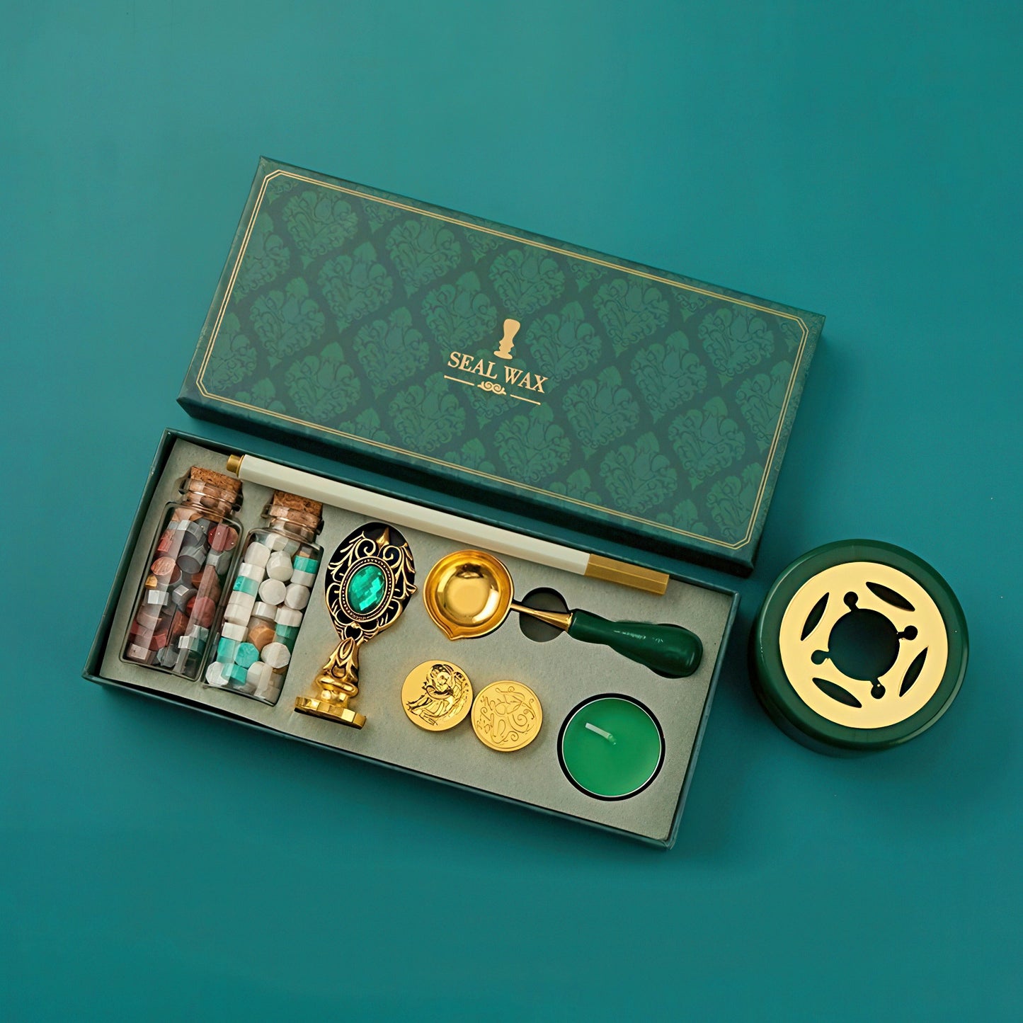 Seal wax kit with various components on a teal background