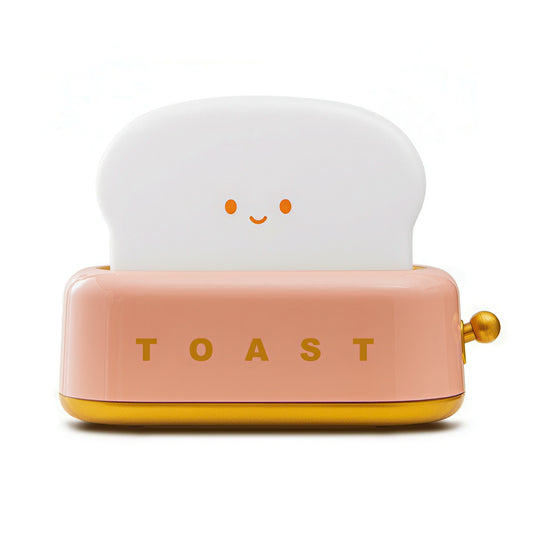 Pink toaster-shaped lamp on a white background.