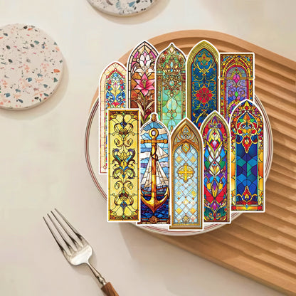 Decorative paper bookmarks with stained glass designs on a plate.