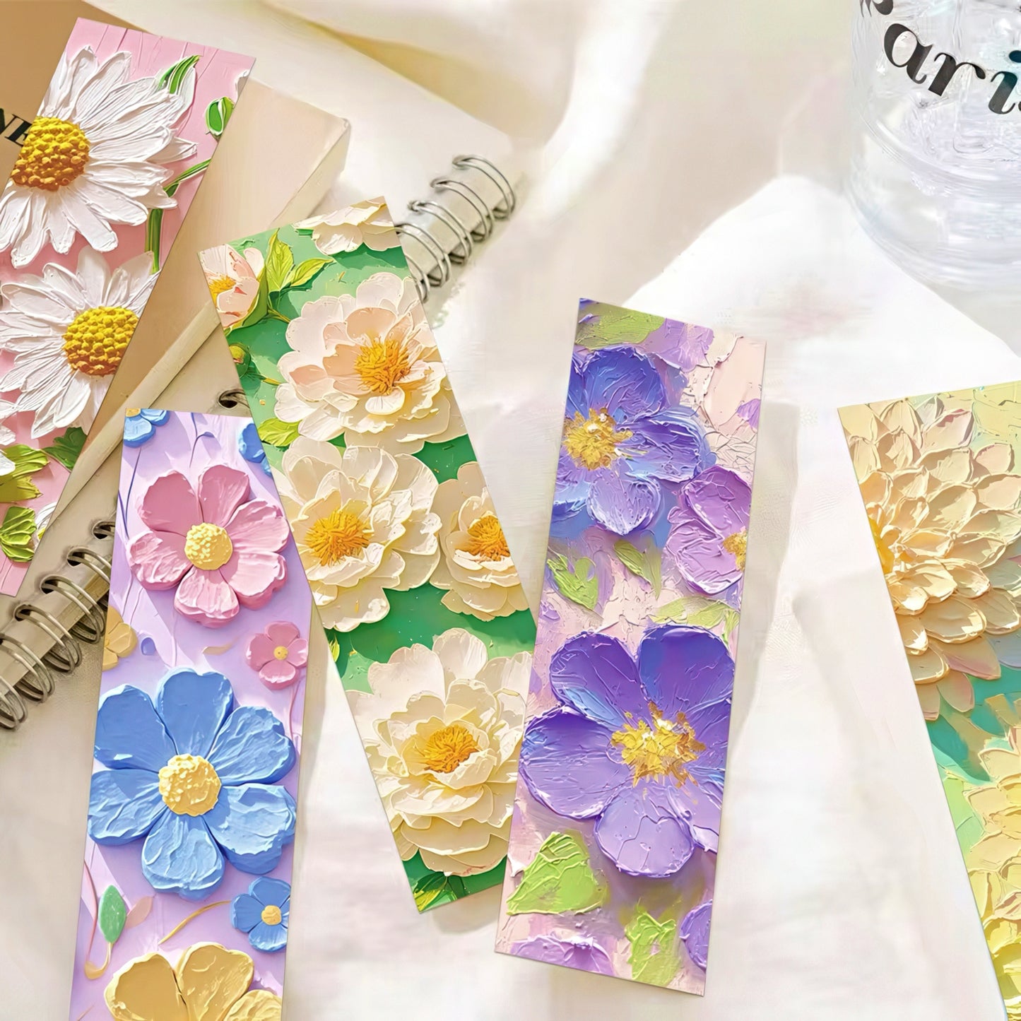 Floral paper bookmarks with colorful flowers on a white surface