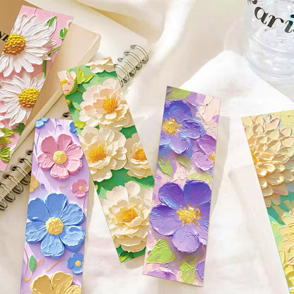 Floral paper bookmarks with colorful flowers on a white surface