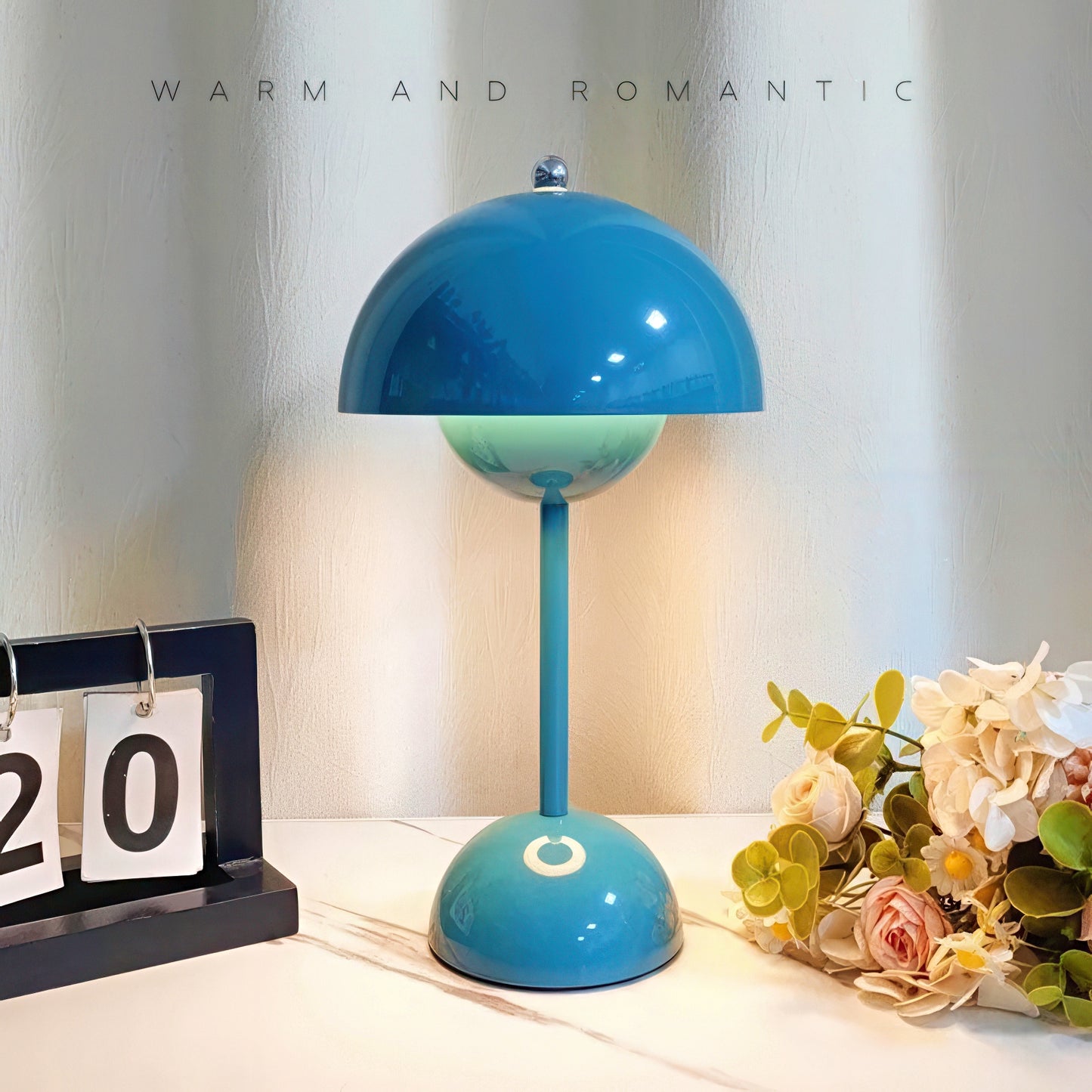 Blue table lamp on a surface with decorative elements.
