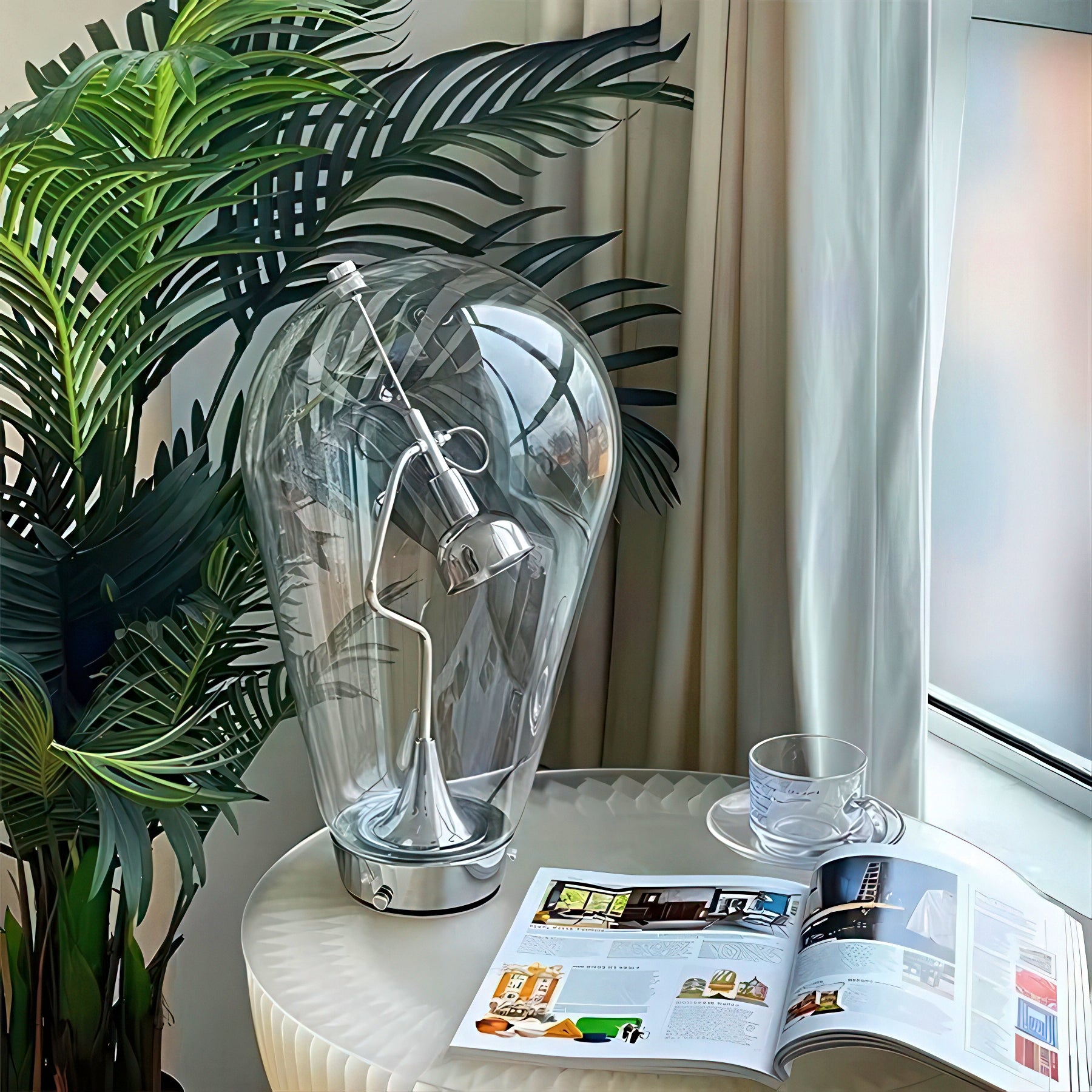 Decorative glass lamp on a table with a magazine and cup, next to a plant and window.