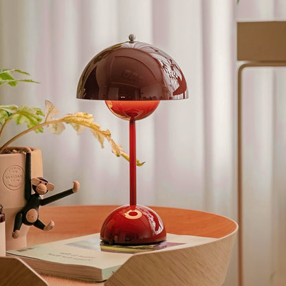 Red table lamp on a wooden surface with a blurred background