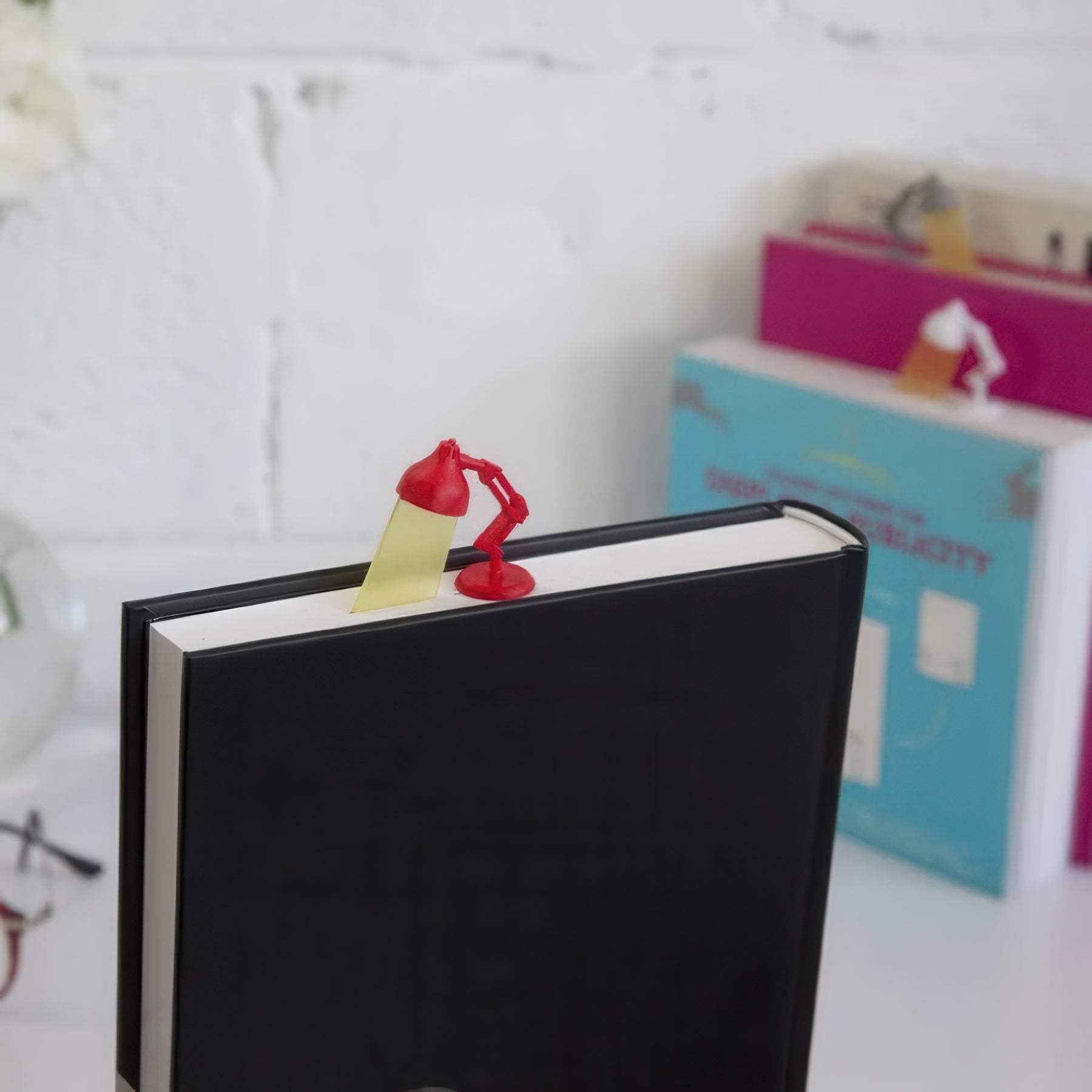 Black book with a lamp shaped plastic bookmark.