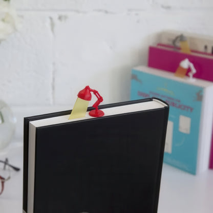 Black book with a lamp shaped plastic bookmark.