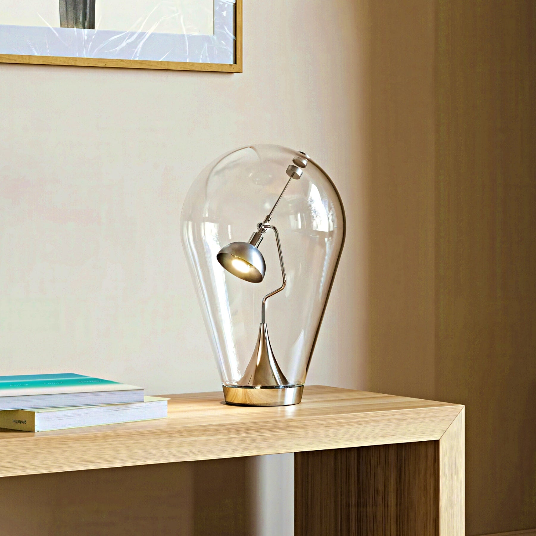 Modern glass table lamp on a wooden surface with a neutral background