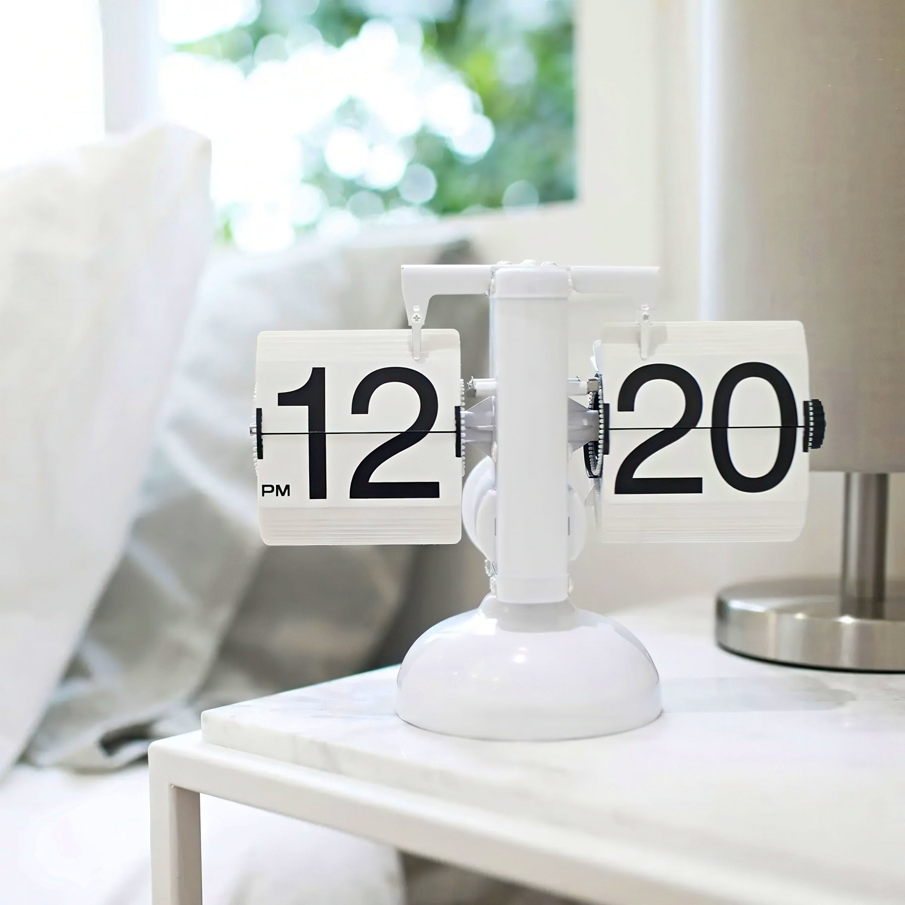 Tabletop clock with flip faces on a white surface