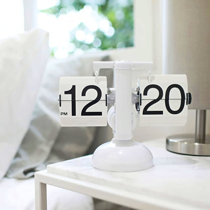 Tabletop clock with flip faces on a white surface