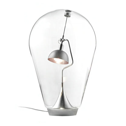 Modern table lamp with clear glass shade and metallic base on a white background