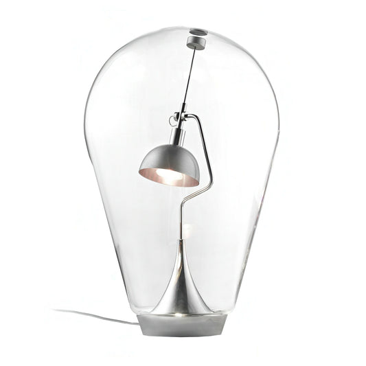 Modern table lamp with clear glass shade and metallic base on a white background
