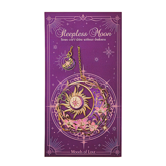 Decorative metal bookmark with sun and moon design.