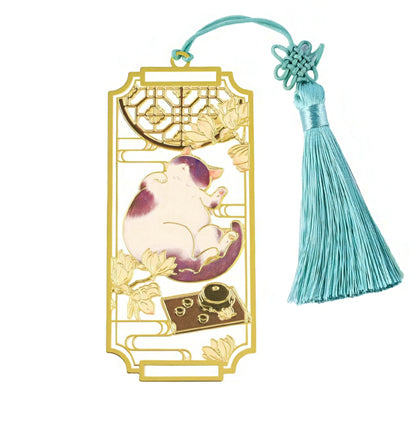 Decorative bookmark with a cat design and tassel on a white background
