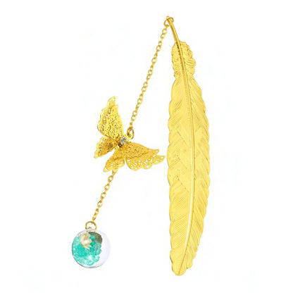 Gold feather-shaped bookmark with butterfly and gemstone pendant on a white background