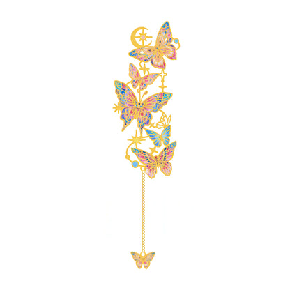 Decorative butterfly charm with gemstones on a white background