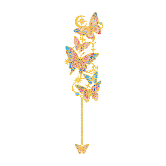 Decorative butterfly charm with gemstones on a white background